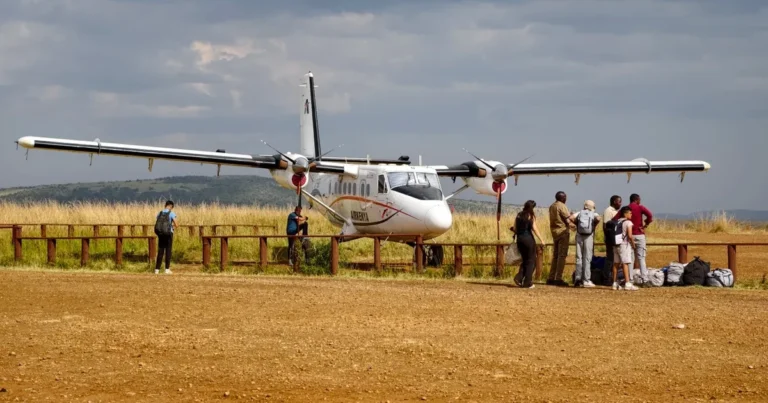 Small safari aircraft waiting with passengers at a bush airstrip in Kenya