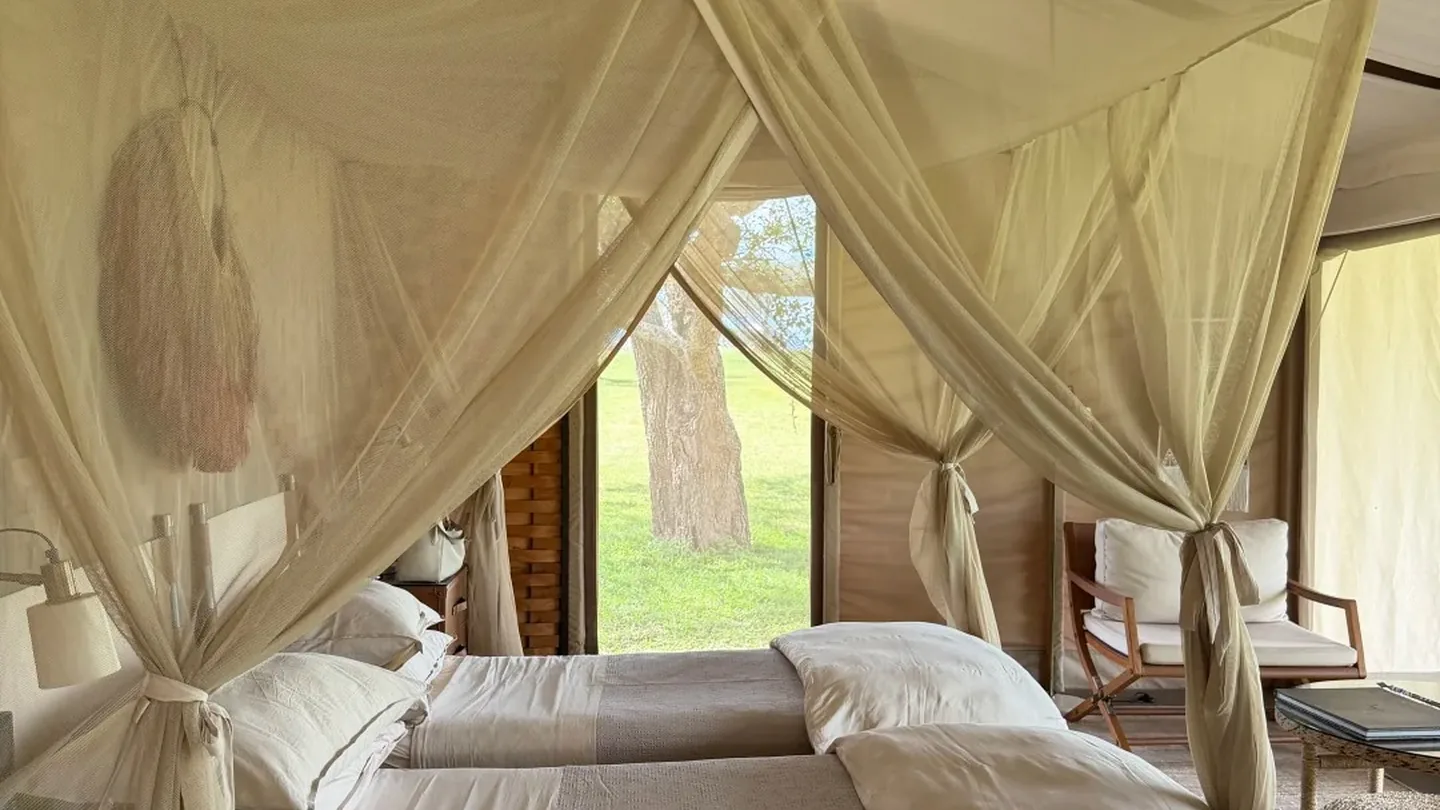 Canopied bed inside a luxury safari lodge in Tanzania