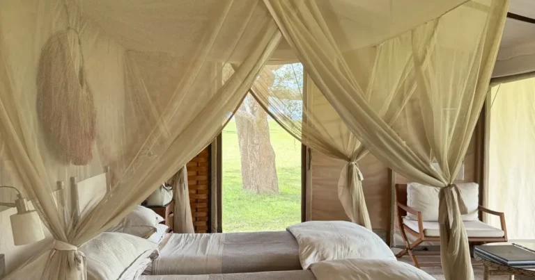 Canopied bed inside a luxury safari lodge in Tanzania